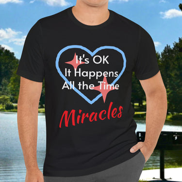 Soft, breathable Bella+Canvas t-shirt made from preshrunk cotton with “Miracles Happen” design message, “It’s OK. It Happens All the Time – Miracles,” inspirational shirt encouraging intimacy with God that produces everyday miracles, man in black t-shirt